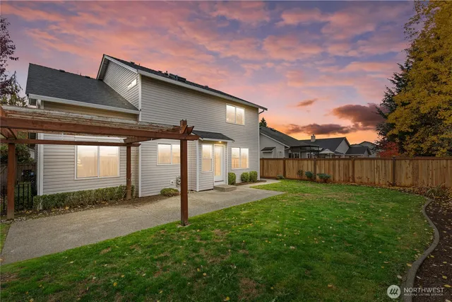 a backyard of a house with table and chairs