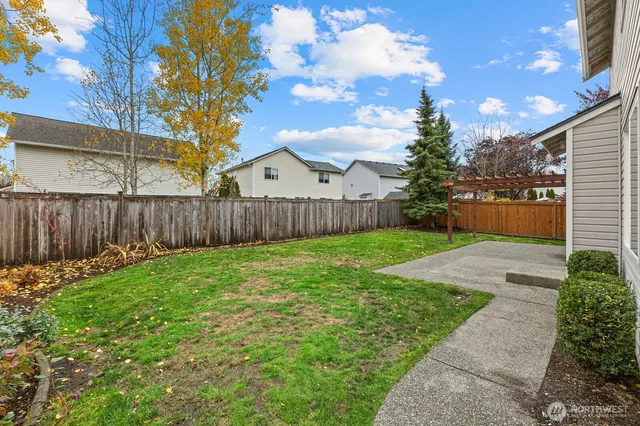 a view of a backyard with sitting area