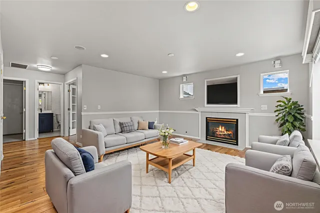 a living room with furniture a fireplace and a flat screen tv