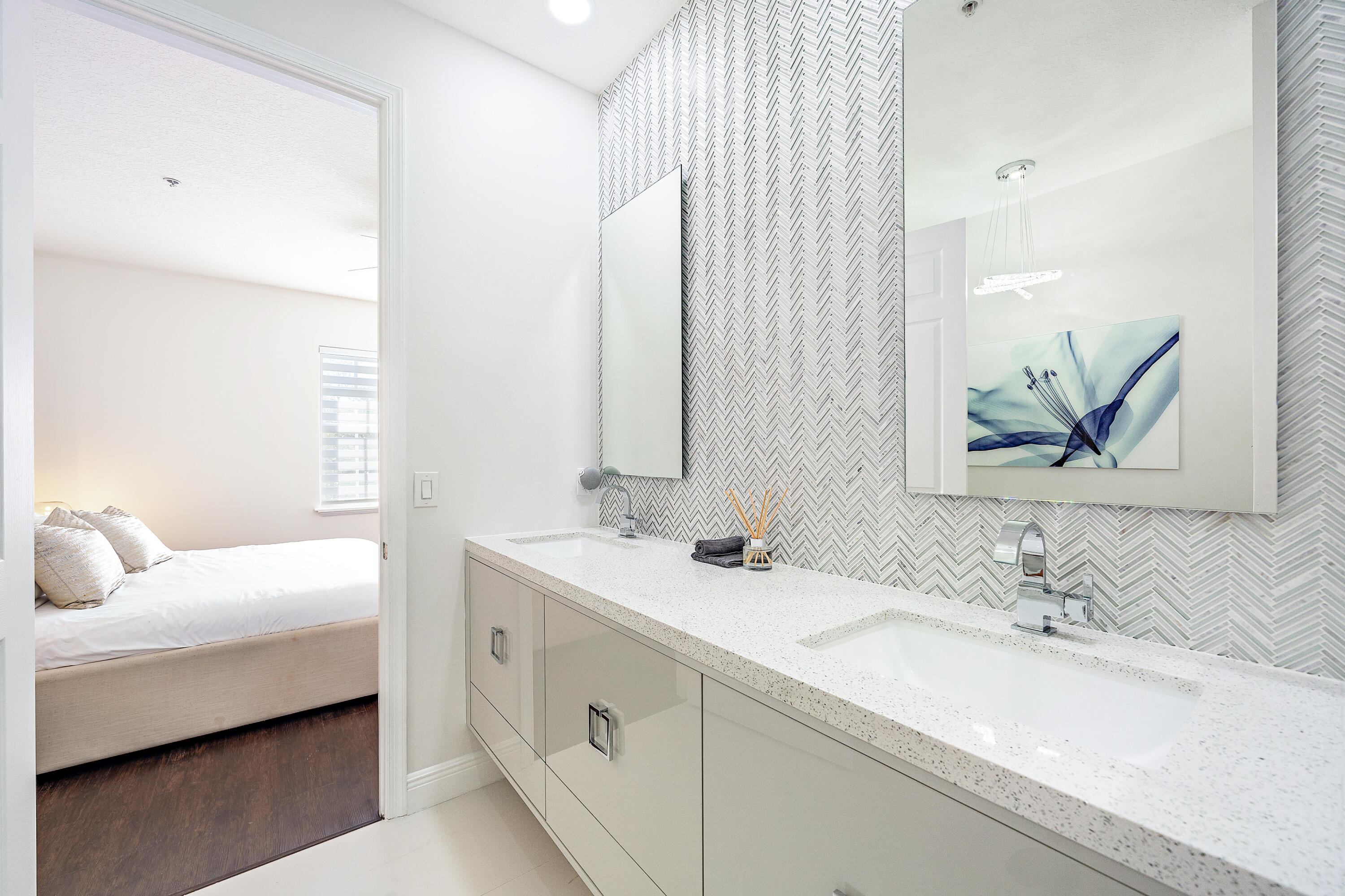 113 West Indian Crossing Circle Jupiter, FL 33458 - Photo 26 of 35 a bathroom with a double vanity sink and a mirror