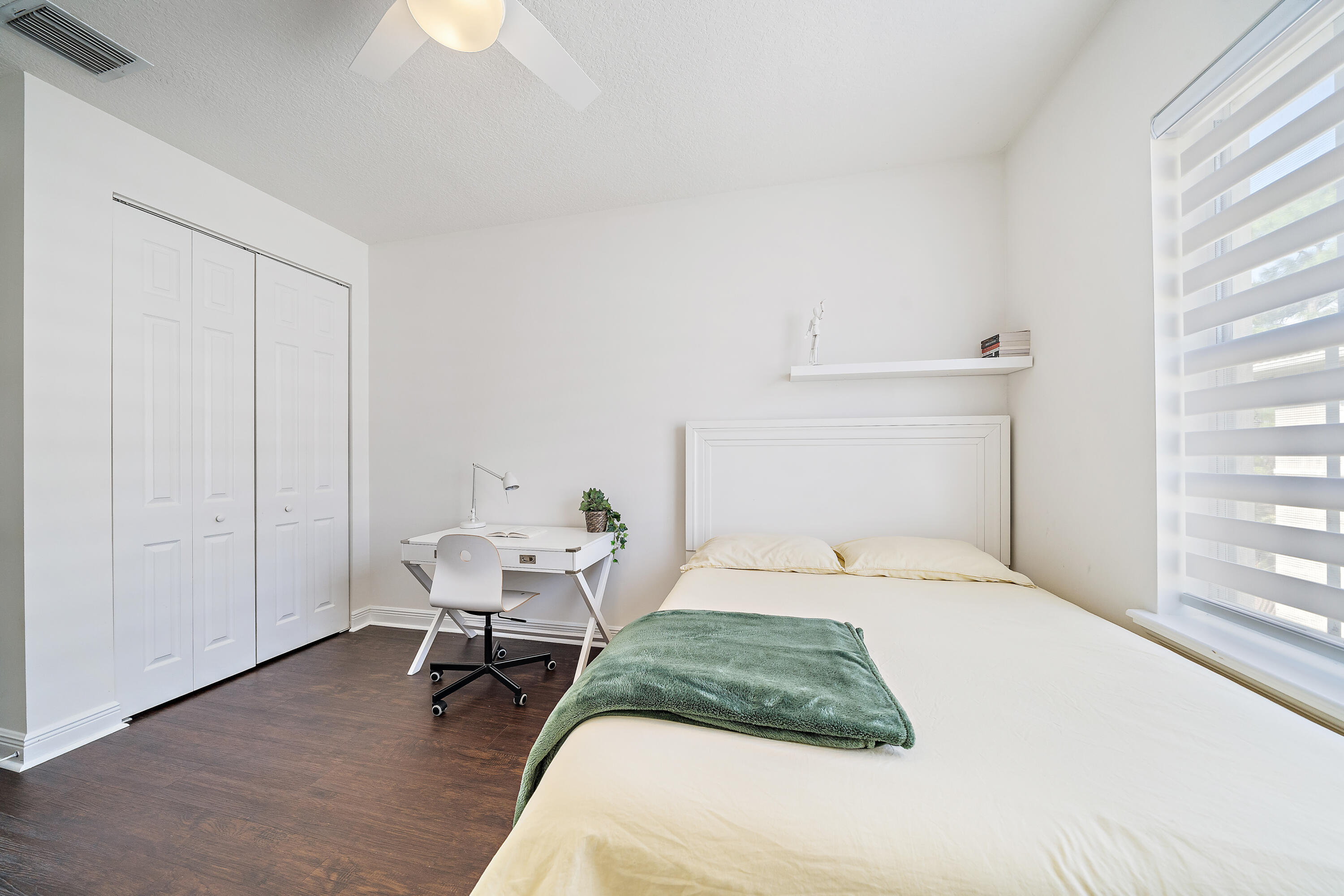 113 West Indian Crossing Circle Jupiter, FL 33458 - Photo 31 of 35 a bedroom with a bed and a window