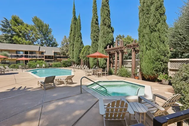 a view of a patio with table and chairs and potted plants with sky view