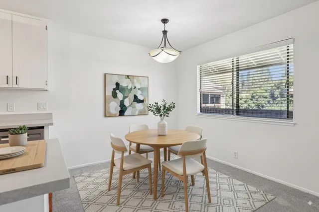 a dining room with furniture a window and a chandelier