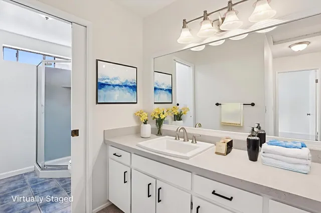 a bathroom with a sink double vanity and a mirror