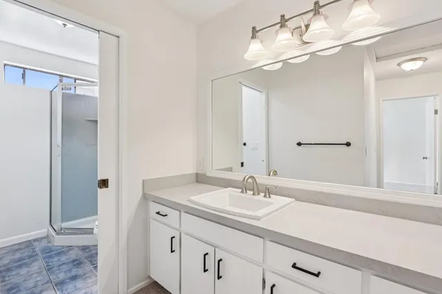 a bathroom with a sink double vanity and a mirror