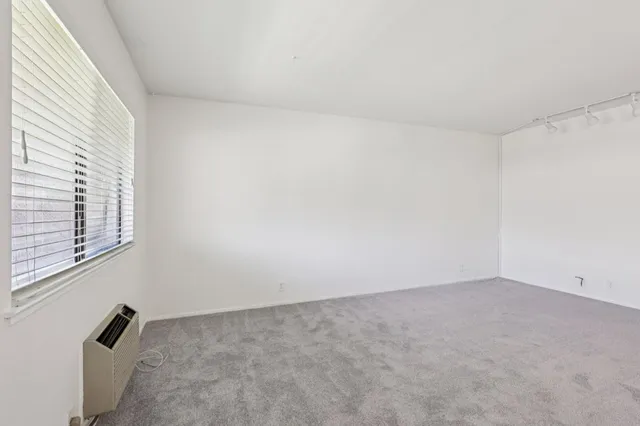 a view of an empty room and a window