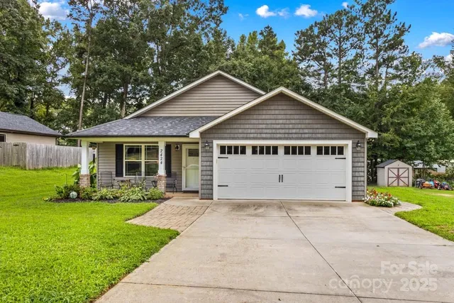 a view of house with yard and green space