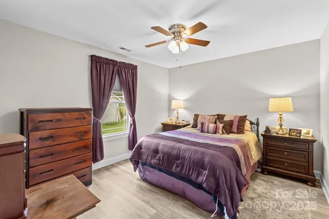 a bedroom with a bed and a ceiling fan