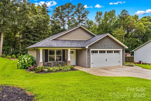 a view of a house with garden and yard