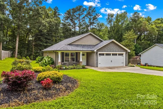 a front view of a house with a yard and fountain