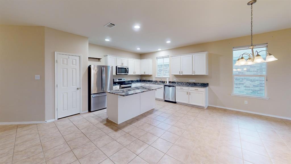 2213 Heaton Street Forney, TX 75126 - Photo 5 of 14 Expansive kitchen featuring a central island, stainless steel appliances, recessed lighting, white cabinetry, and durable tile flooring