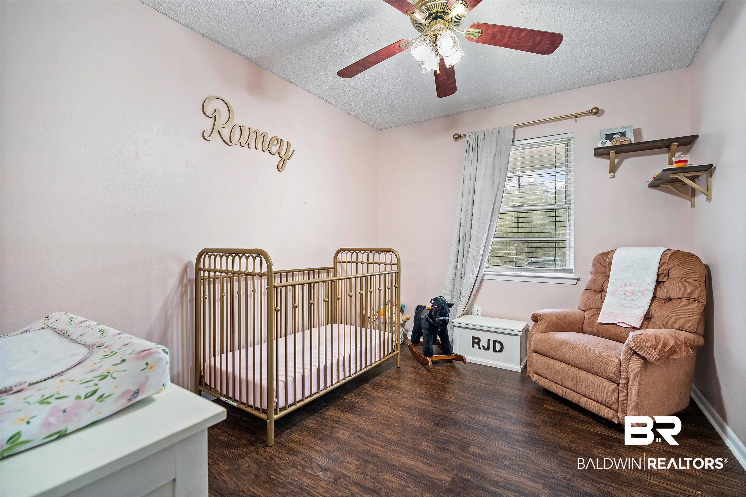 5110 Wilmer Road Wilmer, AL 36587 - Photo 18 of 24 Bedroom with ceiling fan, dark hardwood / wood-style floors, a crib, and a textured ceiling
