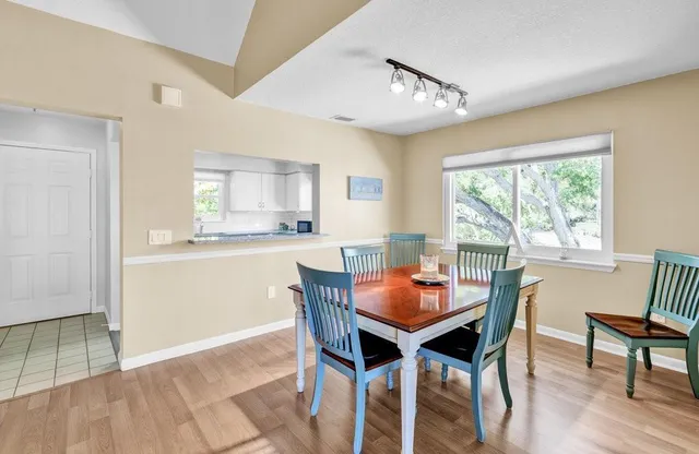 a dining room with furniture and wooden floor