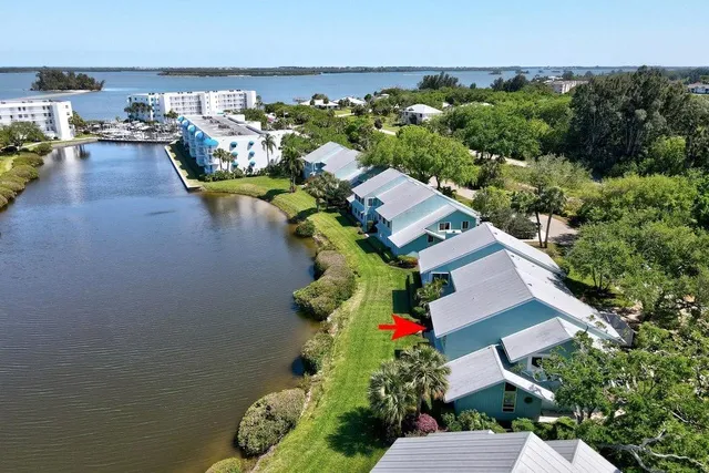 an aerial view of a house with swimming pool and outdoor seating