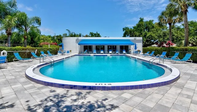 a room with pool table and windows