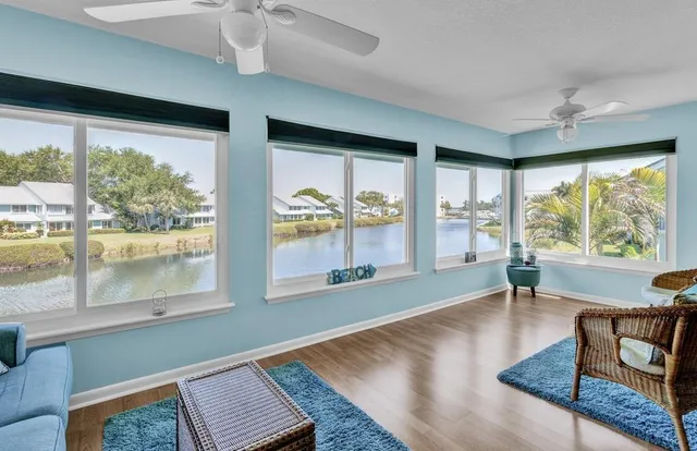 a living room with furniture and large windows