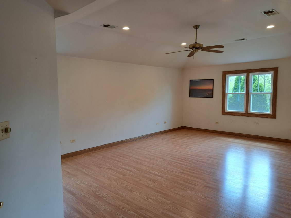 Undisclosed Address Park Ridge, IL 60068 - Photo 12 of 25 wooden floor in an empty room with a window
