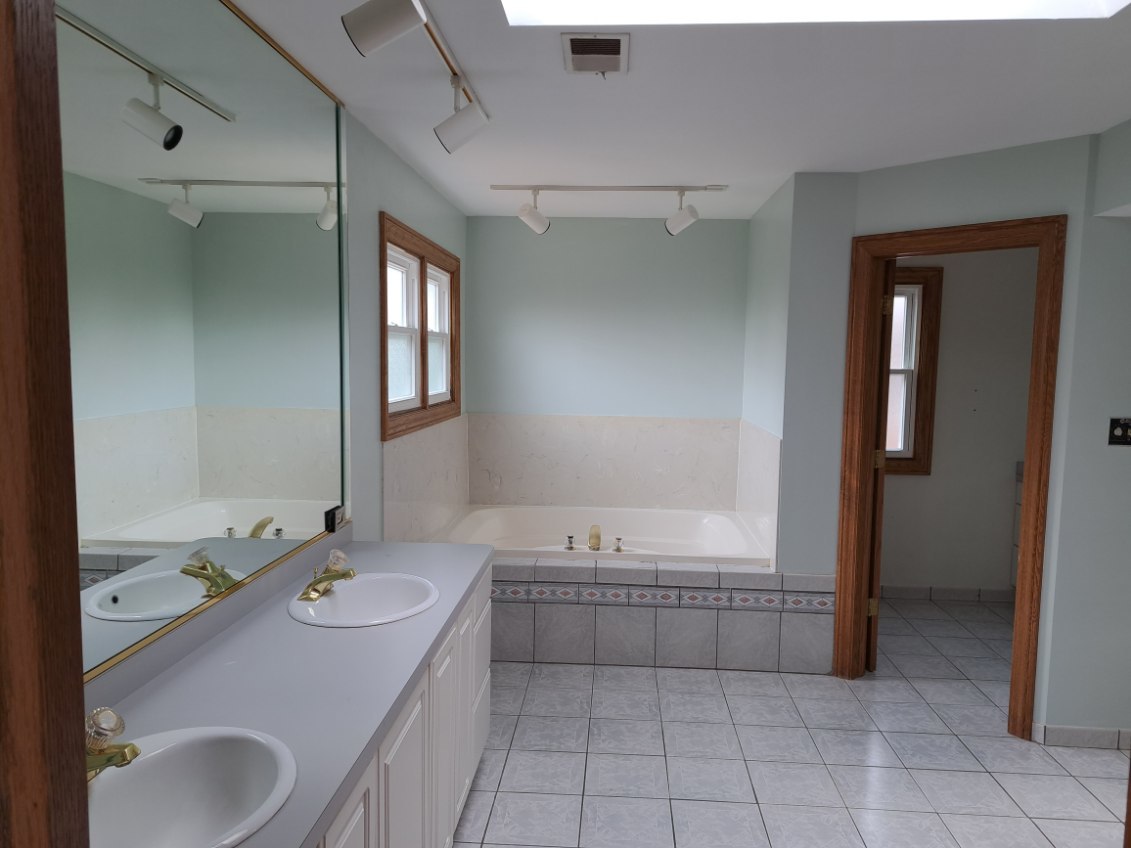 Undisclosed Address Park Ridge, IL 60068 - Photo 16 of 25 a bathroom with a granite countertop sink a toilet and shower