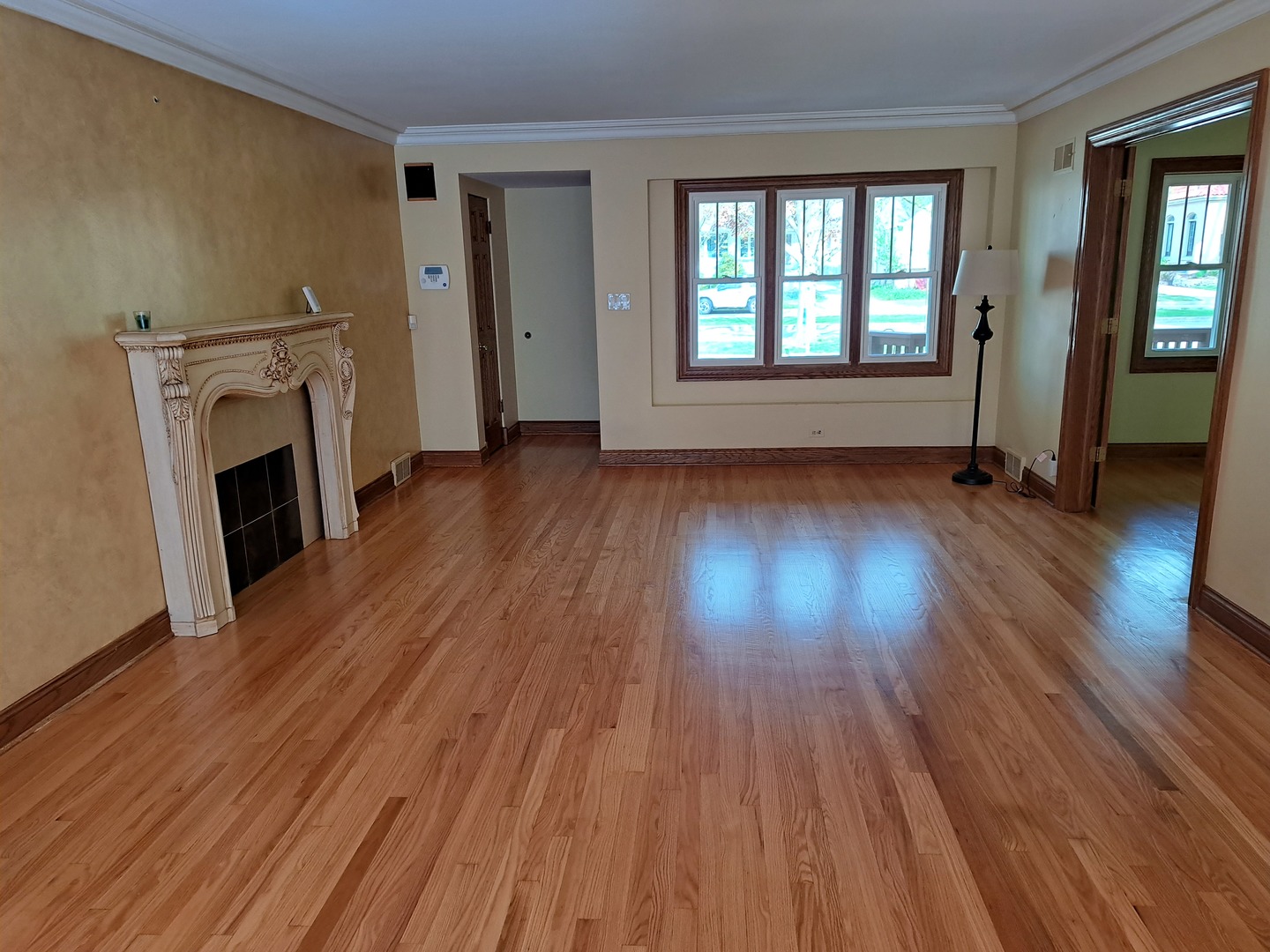 Undisclosed Address Park Ridge, IL 60068 - Photo 3 of 25 an empty room with wooden floor and fireplace