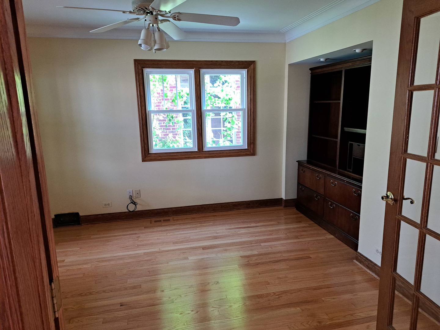 Undisclosed Address Park Ridge, IL 60068 - Photo 5 of 25 a view of an empty room with a window and wooden floor