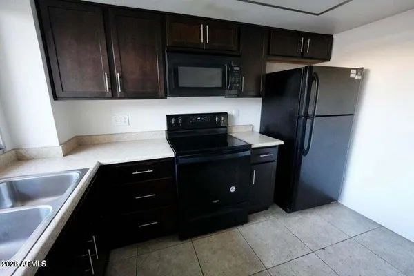 a kitchen with a refrigerator stove and microwave