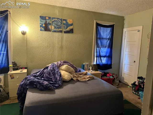 a bedroom with a bed and a mirror