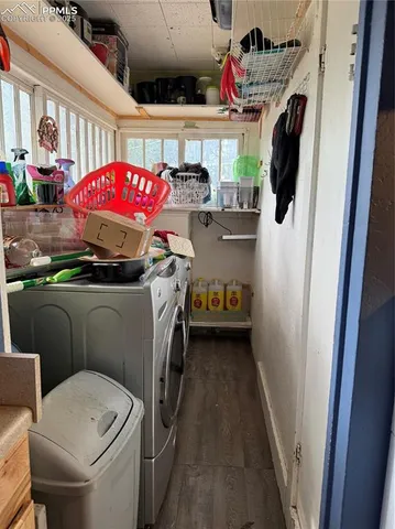 a utility room with dryer washer and a view of living room