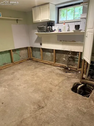 a view of a room with gym equipment and a window