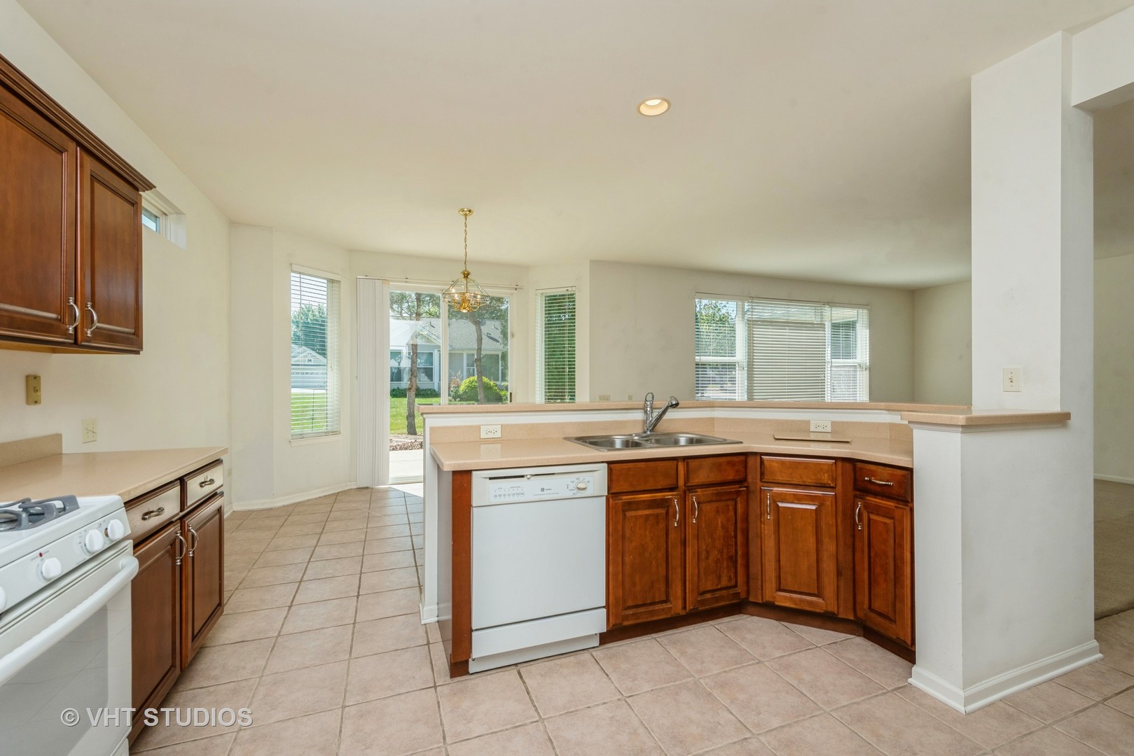 13065 Big Horn Drive Huntley, IL 60142 - Photo 5 of 14 a kitchen with a sink stove and cabinets