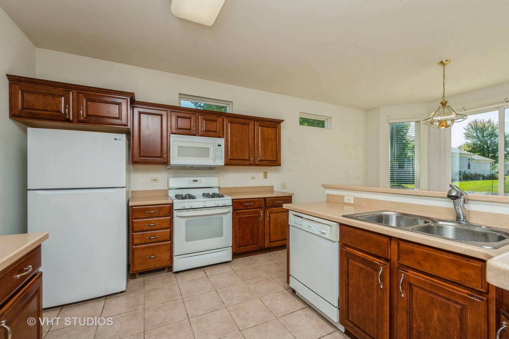 13065 Big Horn Drive Huntley, IL 60142 - Photo 6 of 14 a kitchen with stainless steel appliances granite countertop a sink stove and refrigerator