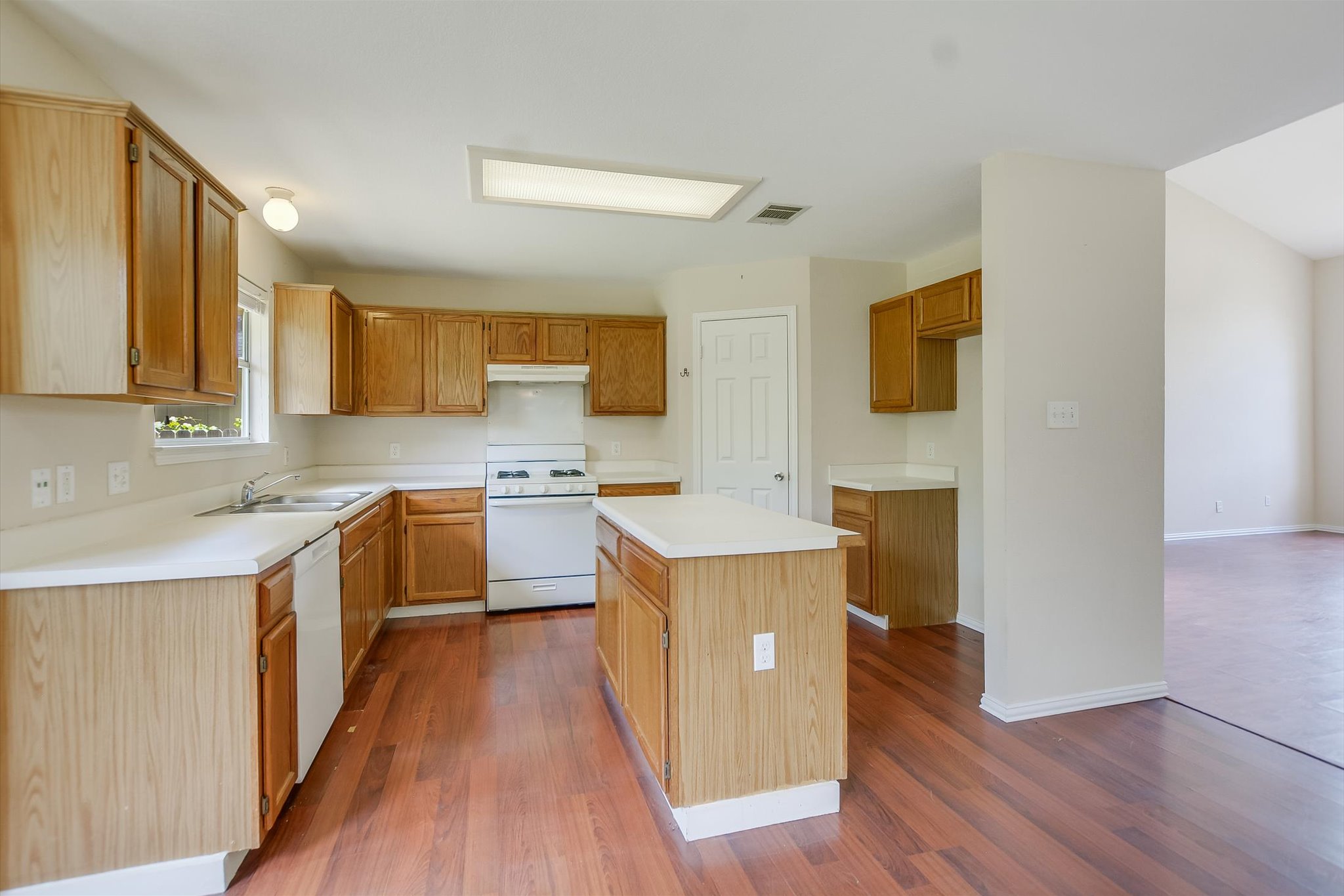1008 Double File Trail Round Rock, TX 78665 - Photo 8 of 20 A well-lit kitchen with rich hardwood flooring and a central island awaits your culinary creations.