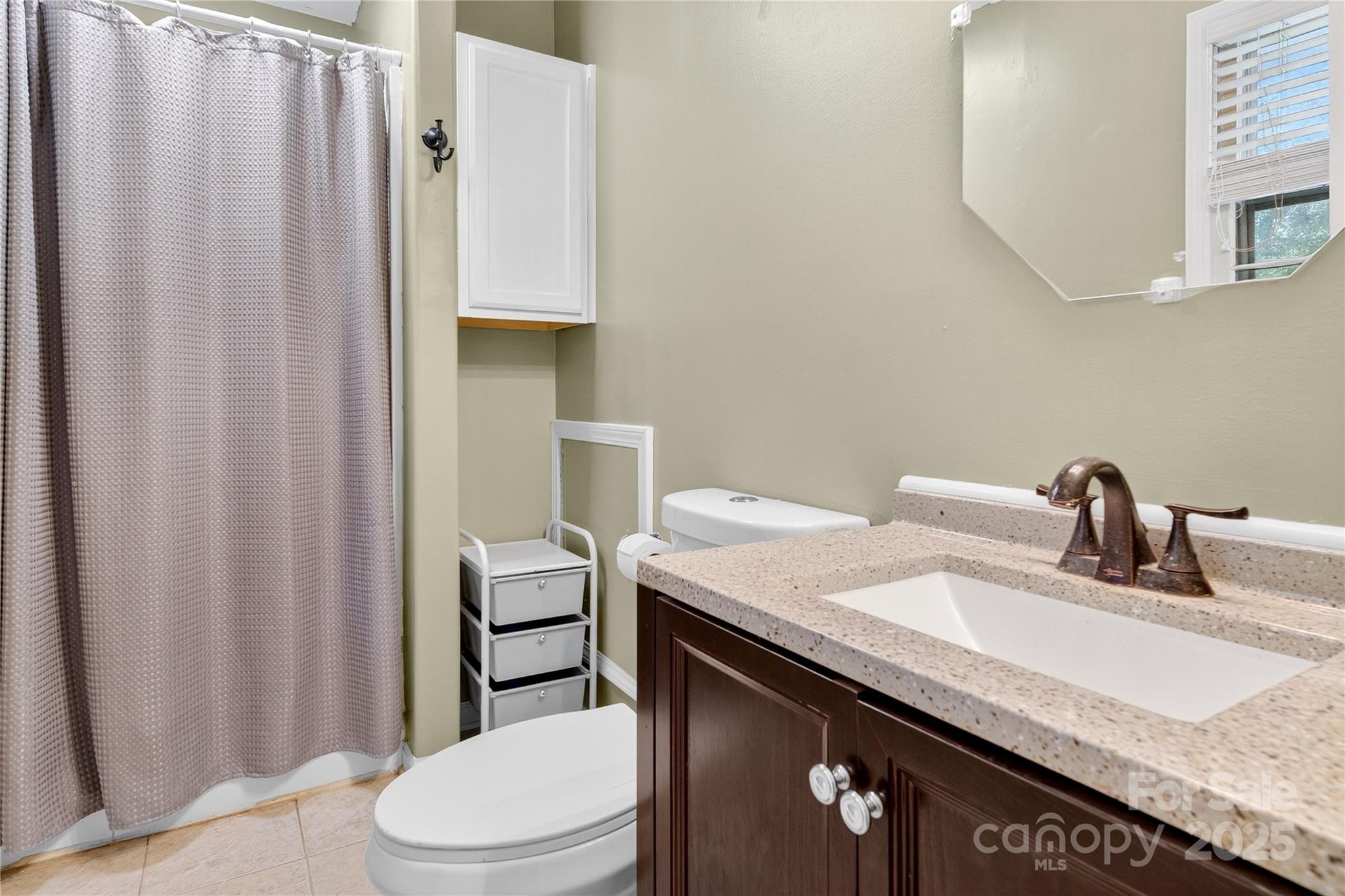 205 Airport Road Monroe, NC 28110 - Photo 19 of 32 a bathroom with a granite countertop sink and a mirror