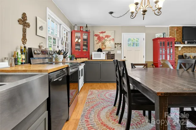 a living room with furniture dining area and a large window