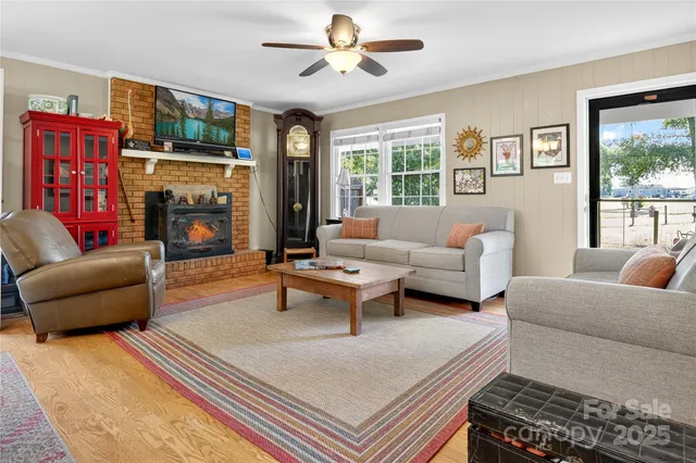 a living room with furniture a dining table and a chandelier