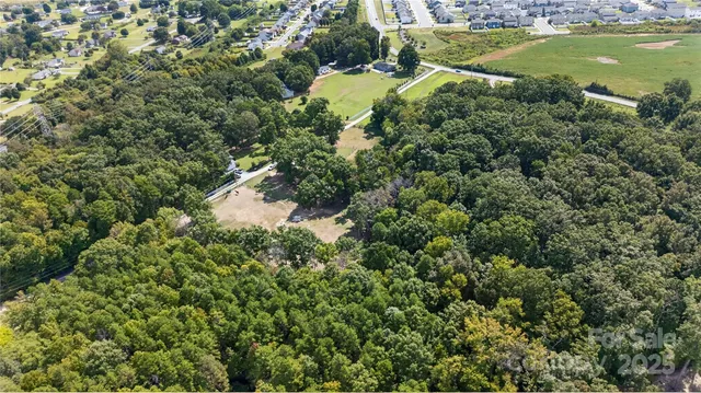 an aerial view of a residential houses with yard