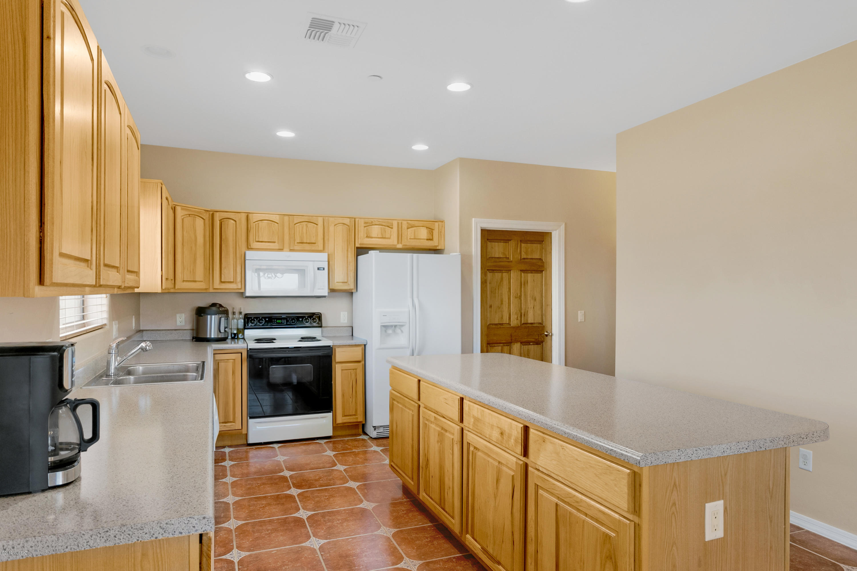 21960 South Helvetia Road Sahuarita, AZ 85629 - Photo 8 of 29 a kitchen with stainless steel appliances granite countertop a stove top oven a sink and dishwasher