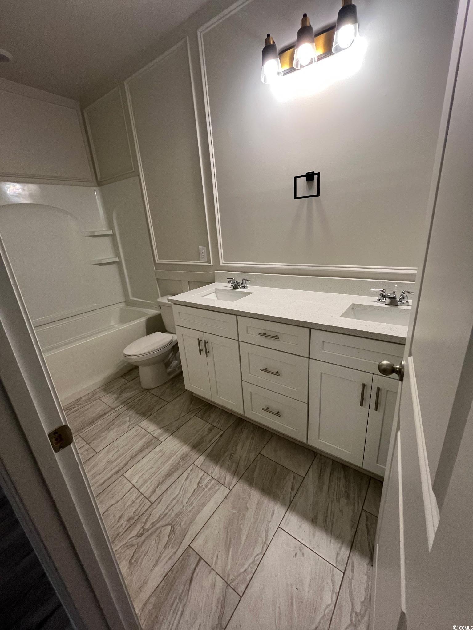 1505 1st Avenue Conway, SC 29526 - Photo 5 of 9 Bathroom with double vanity, tub / shower combination, and light marble finish flooring