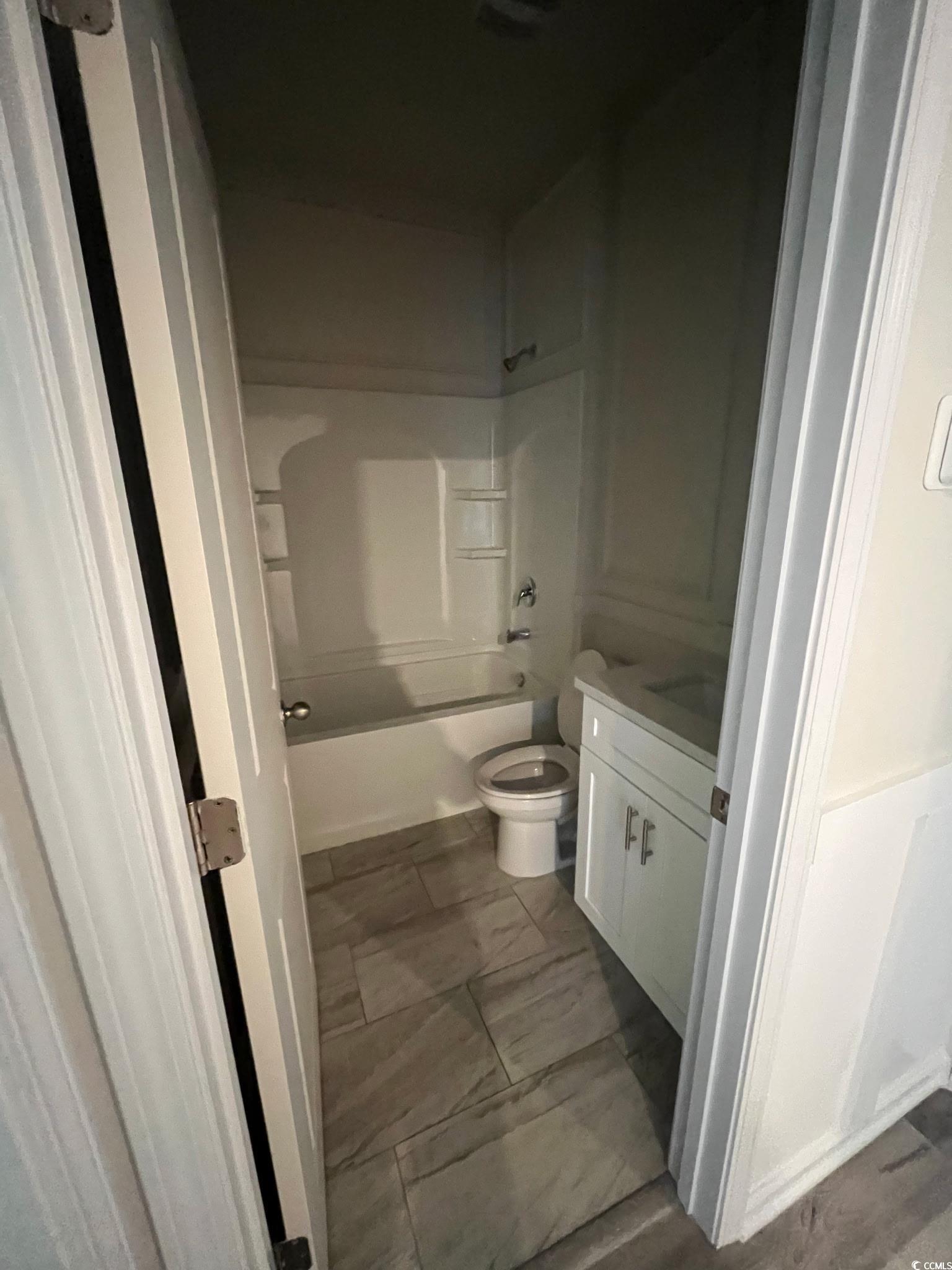 1505 1st Avenue Conway, SC 29526 - Photo 7 of 9 Bathroom featuring vanity, shower / bathtub combination, and light marble finish floors