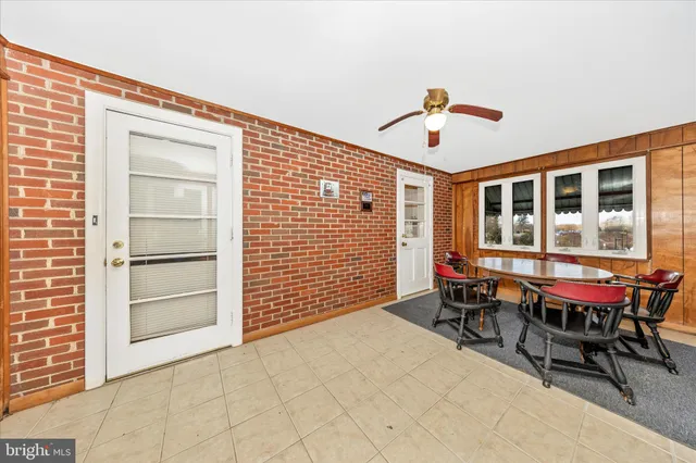 a room with stainless steel appliances kitchen island granite countertop a stove and a refrigerator