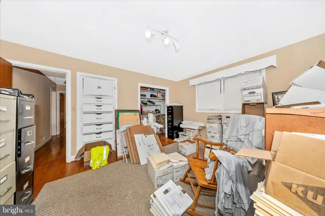 a view of a workspace with furniture and a flat screen tv