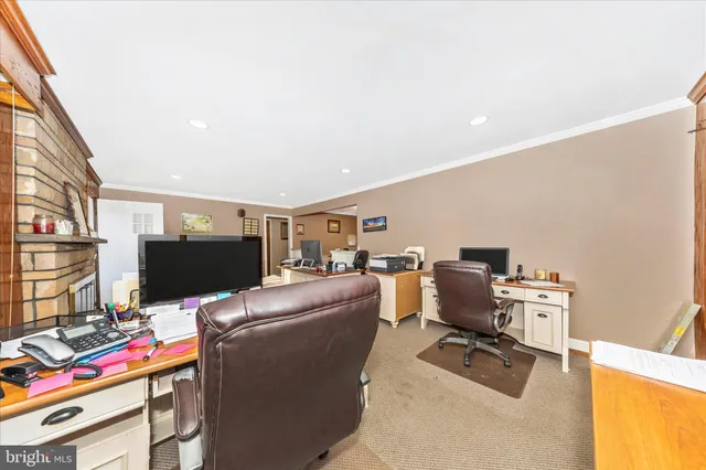 a living room with furniture a large window and a flat screen tv