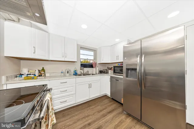 a kitchen with granite countertop a stove sink and cabinets