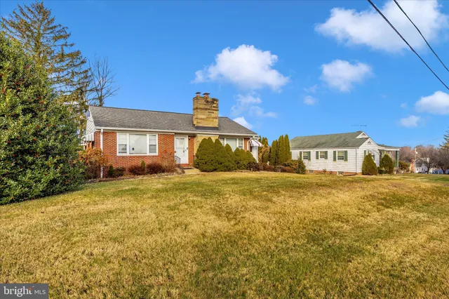 a swimming pool with outdoor seating and yard