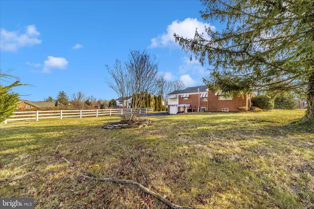 a bathroom with a granite countertop sink and a window