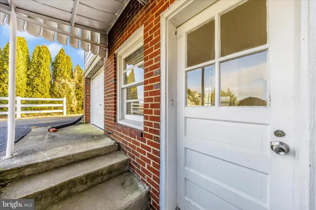 a front view of a house with a yard and lake view