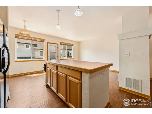 a view of a kitchen with an entryway and wooden floor