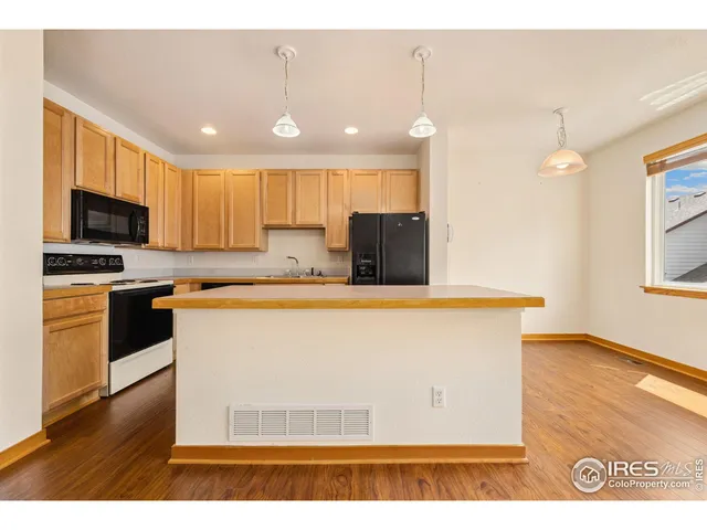 a view of kitchen with cabinets microwave and stove