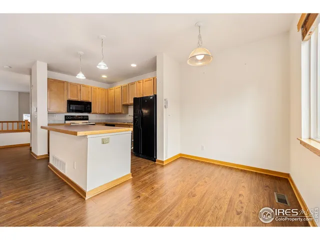 a view of kitchen with cabinets and wooden floor