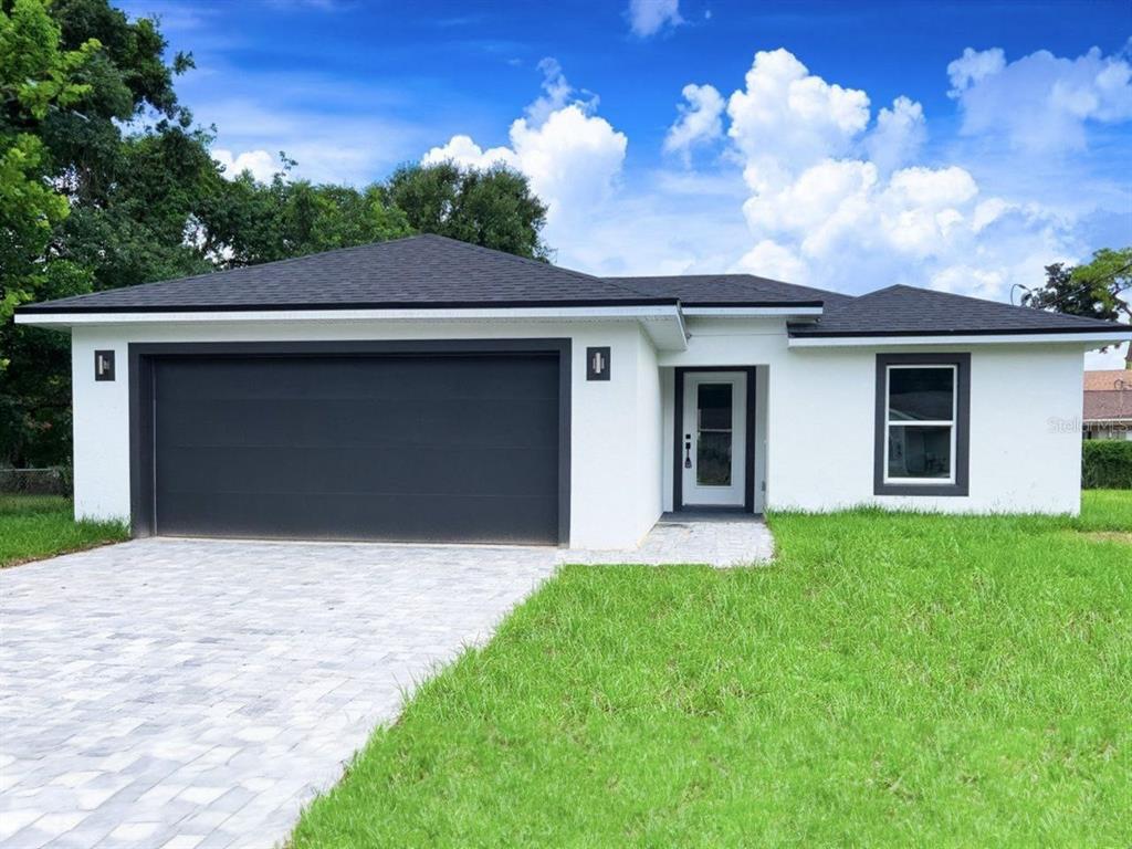 a front view of a house with a yard and garage