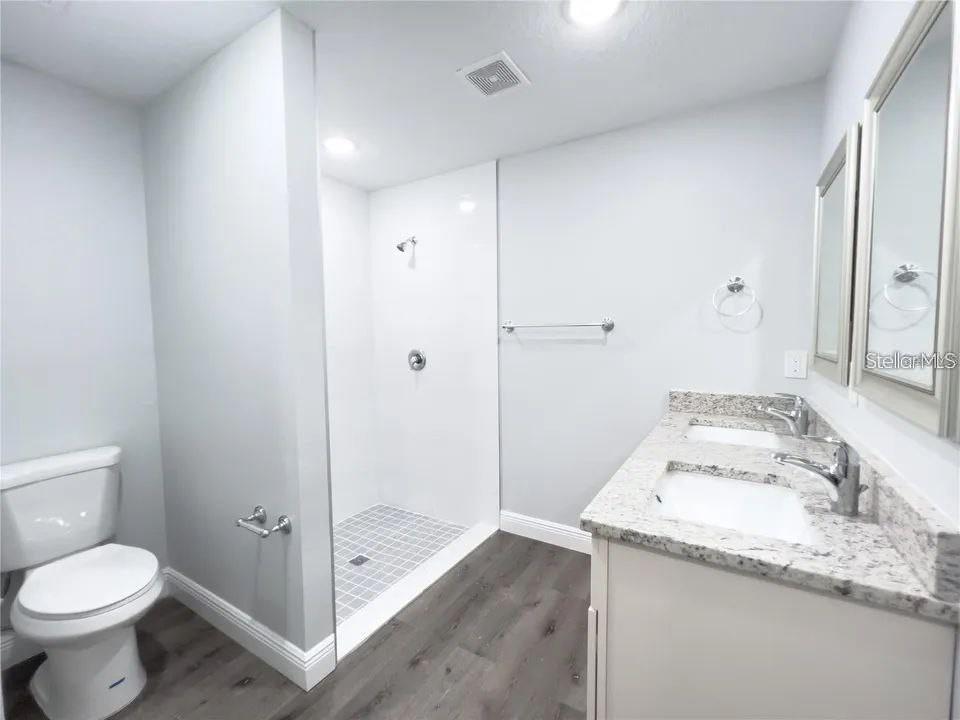 66 Walnut Place Ocala, FL 34480 - Photo 5 of 8 a bathroom with a granite countertop sink toilet and shower